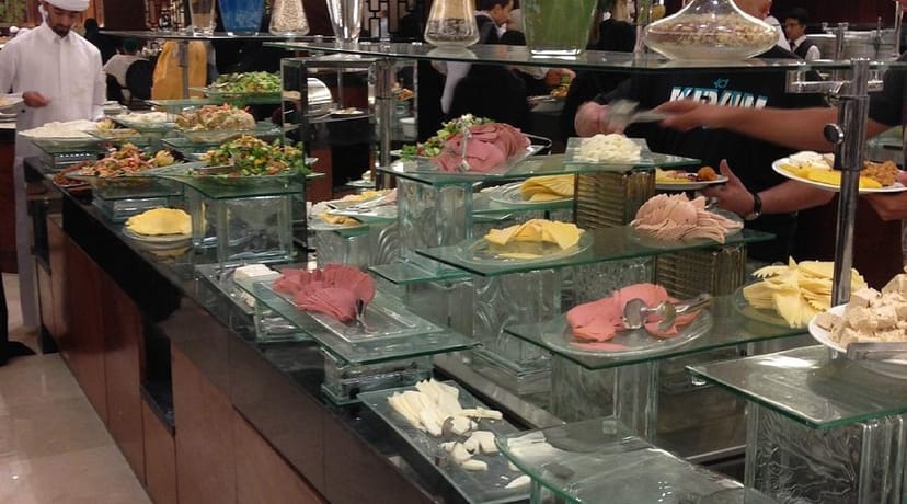Al Ruwad Restaurant high-end buffet with tiered glass risers for luxury catering events.