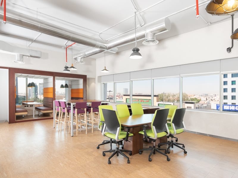 Modern hybrid meeting space with booth and boardroom seating in Olaya Towers for agile teams.
