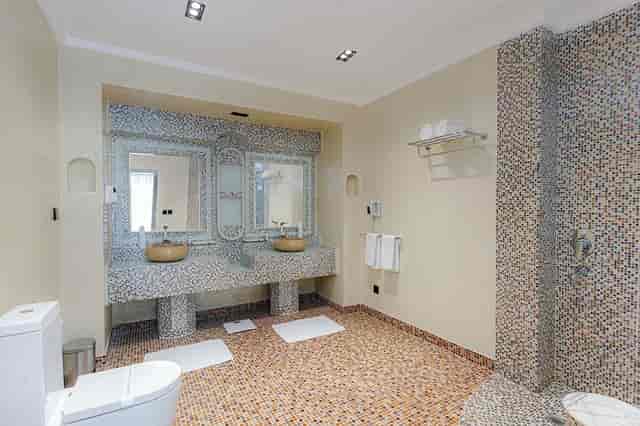 Luxury hotel suite bathroom with double sinks for site inspections and room block vetting.