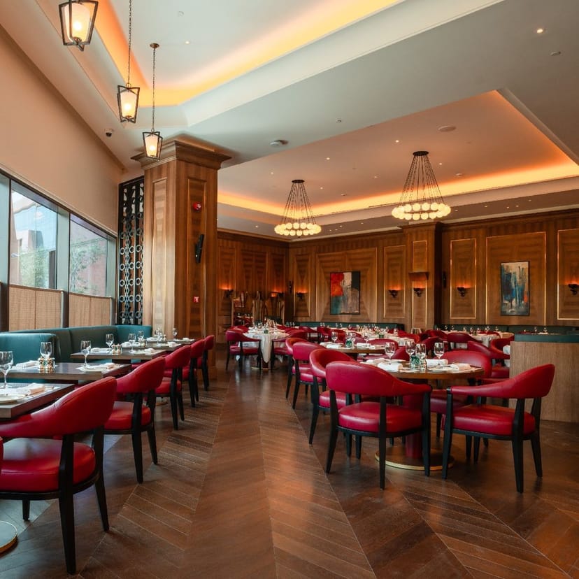 Upscale restaurant with red chairs for corporate dinner and networking event venue.
