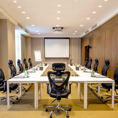 Luxury hotel conference room with U-shape seating for professional business meetings and workshops.