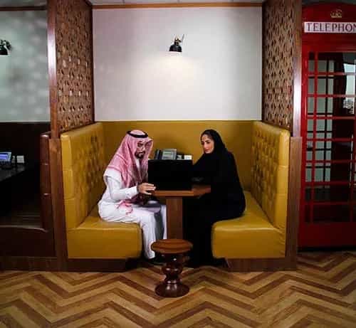Private high-backed booth in Al Akaria Plaza coworking space for collaborative business meetings.