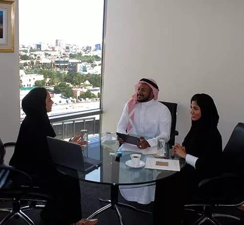 Boardroom meeting at Al Akaria Plaza featuring city views for executive strategy sessions.