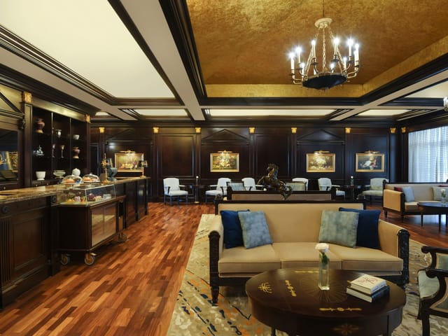 Elite lounge at Al Aziziyah Boutique Hotel: wood-paneled VIP hospitality and conference space.