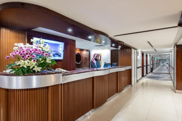 Golden Tulip Al Nasiriah polished reception desk for hotel events and conference registration.