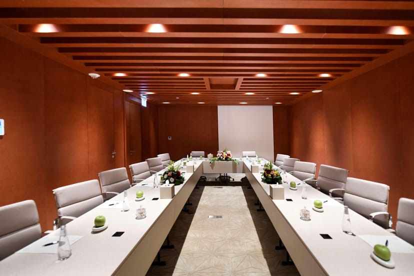 U-shape boardroom at Golden Tulip Al Nasiriah featuring wood paneling for corporate meetings.