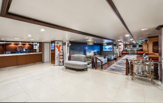 Golden Tulip Al Nasiriah hotel lobby featuring registration area and breakout networking space.