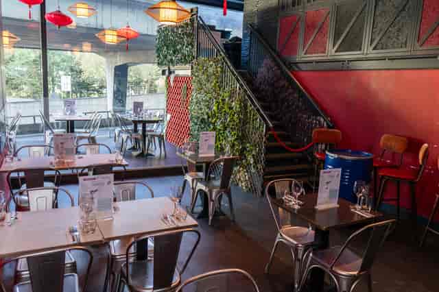 Vibrant event space at HUCKSTER London with tables, ideal for casual dining and meetings.