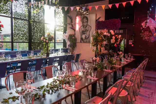 Elegant event space in HUCKSTER London with greenery, ideal for weddings and corporate events.