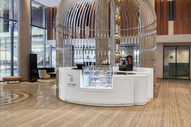 Branded coffee kiosk in Radisson Blu Riyadh exhibition hall for corporate networking events.