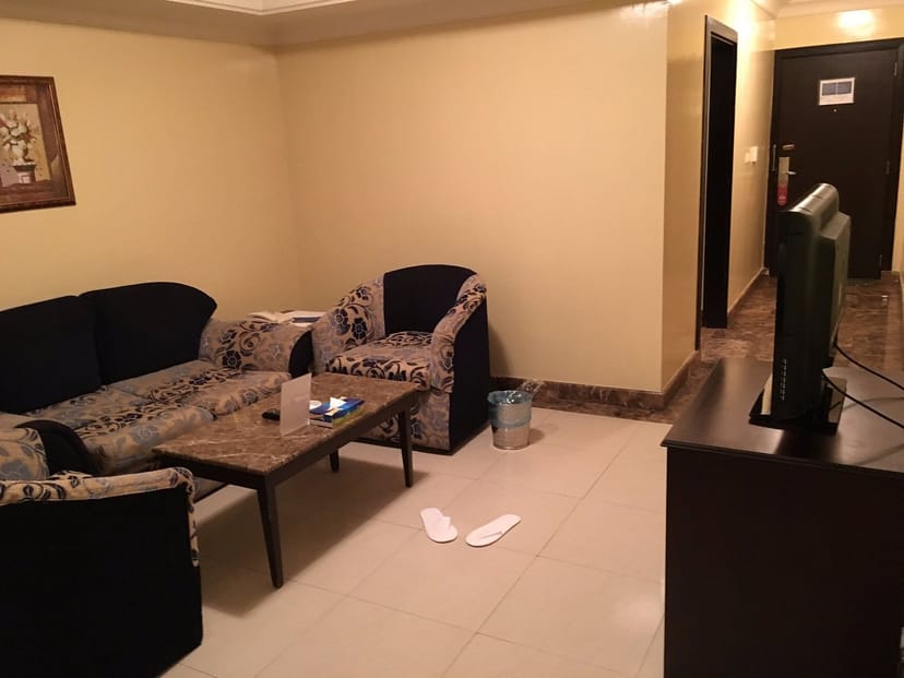 Cluttered Tulip Inn Riyadh hotel suite, substandard interior for corporate event site inspection.