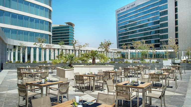 Outdoor event space at Hilton Riyadh with stylish seating for networking and meetings.