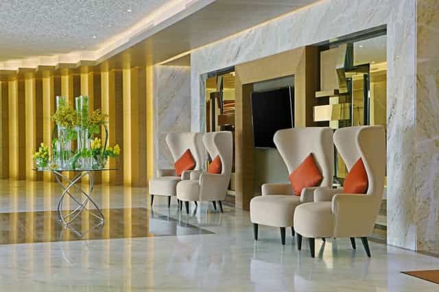 Modern meeting room at DoubleTree by Hilton Riyadh, featuring elegant chairs and floral decor.
