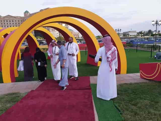Event planner branding: Architectural archway entrance for outdoor corporate event.