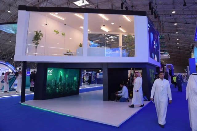 Double-decker trade show booth with LED branding for corporate event planning and expo displays.