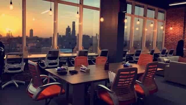 Flexible coworking space with sunset view for professional board meetings and breakout sessions.