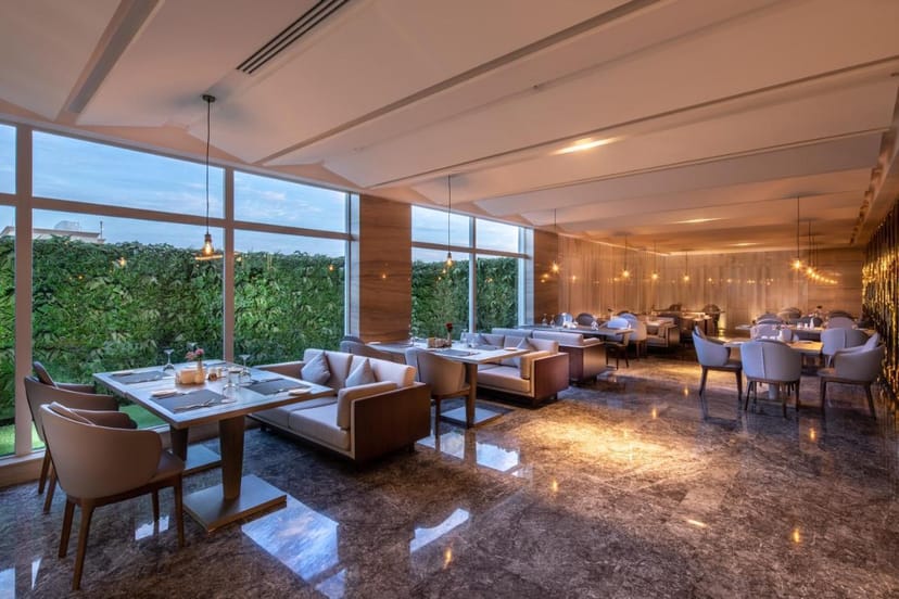 Cafe in Braira Al Nakheel Hotel with marble floors, perfect for corporate lunch and networking.
