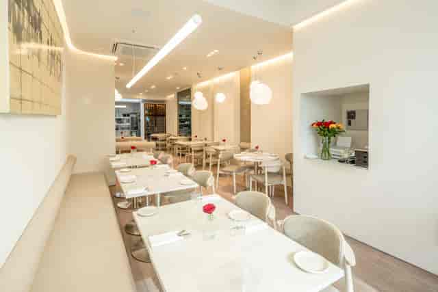 Minimalist restaurant dining space for corporate luncheon and VIP networking event in Botwa.
