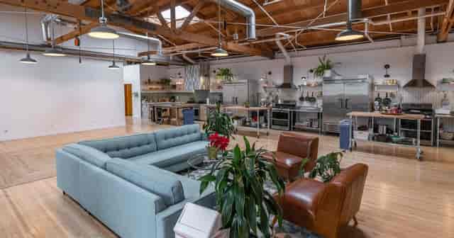 Industrial-chic event venue with professional kitchen for culinary workshops and brand activations.