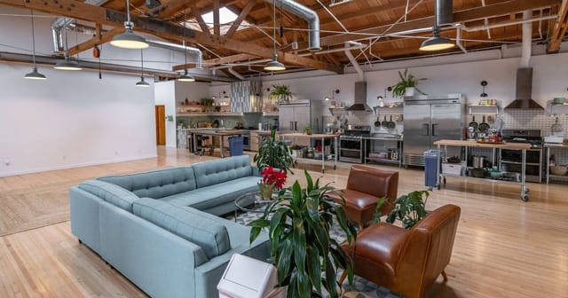 Industrial-chic event venue with professional kitchen for culinary workshops and brand activations.