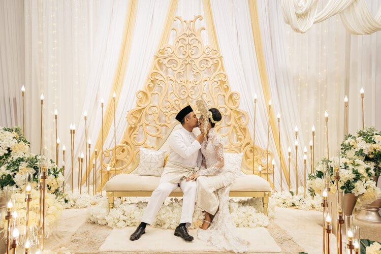 Malay wedding stage design at Tiara Waterfront with dramatic lighting and intricate decor.