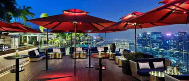 Skybar rooftop lounge with skyline view, perfect for premium cocktail reception and networking.
