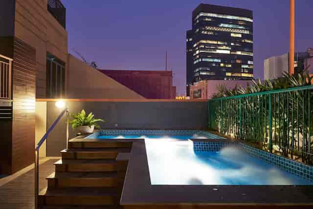 Rooftop suite at Hotel Bencoolen with skyline view for cocktail receptions and networking events.