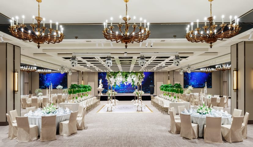 Elegant ballroom event setup with tiered chandeliers for luxury wedding and gala venues.