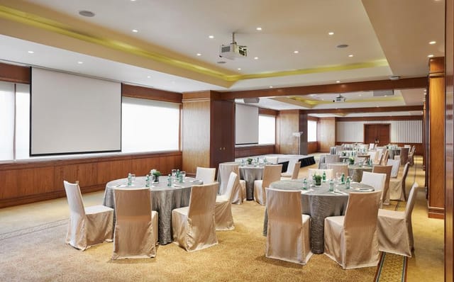 Conrad Singapore Orchard banquet-style conference room with natural light for corporate events.
