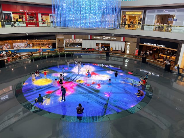 Interactive floor projection at teamLab Digital Light Canvas for experiential event activation.