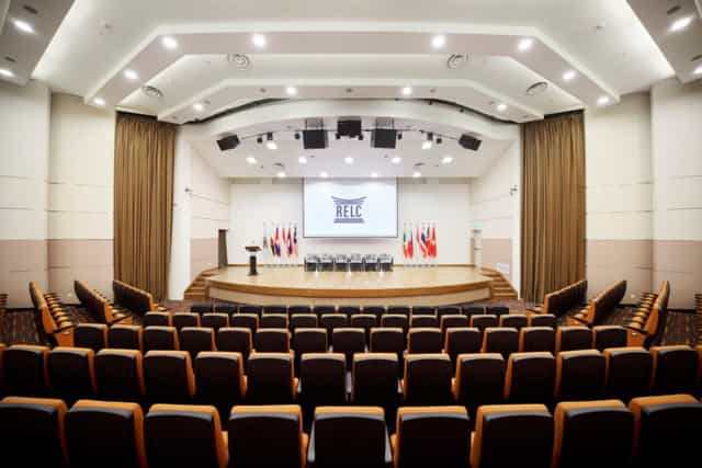 RELC International Hotel auditorium with stage for conferences and formal plenary events.