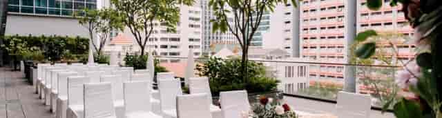 Intimate wedding ceremony at Mercure Singapore Bugis rooftop with city skyline backdrop.