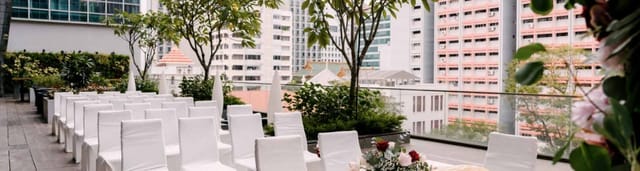 Intimate wedding ceremony at Mercure Singapore Bugis rooftop with city skyline backdrop.