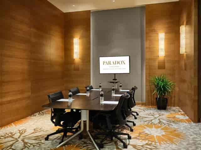 Sophisticated boardroom with wood paneling for executive meetings and strategy sessions.