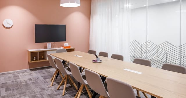Minimalist boardroom with A/V for 10 guests, ideal for team collaboration and corporate meetings.