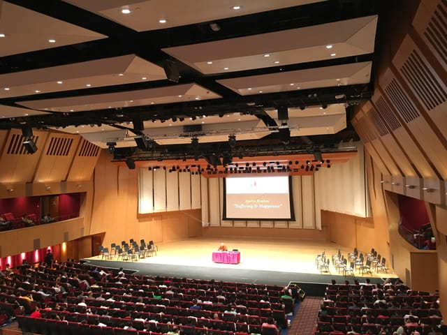 Keynote auditorium with tiered seating for plenary sessions and academic conferences.