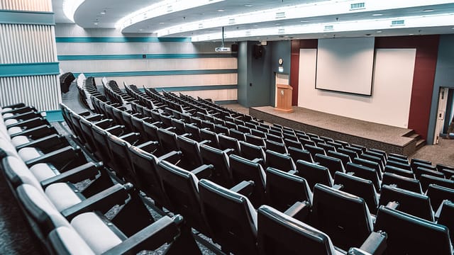 Tiered auditorium for formal presentations and educational keynote sessions.