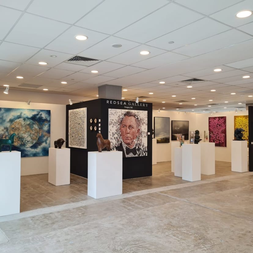 Minimalist REDSEA Gallery pop-up space with spot lighting for private events and networking.