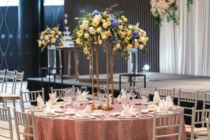 Elegant gala setup at Village Square with floral centerpieces and silver chiavari chairs.