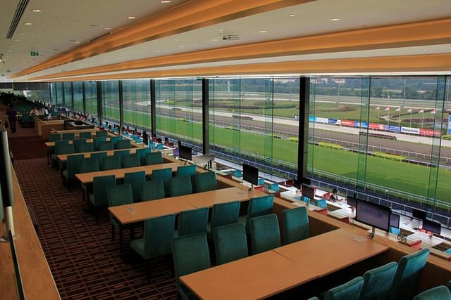 Corporate boxes at Singapore Turf Club with panoramic racetrack views for business events.