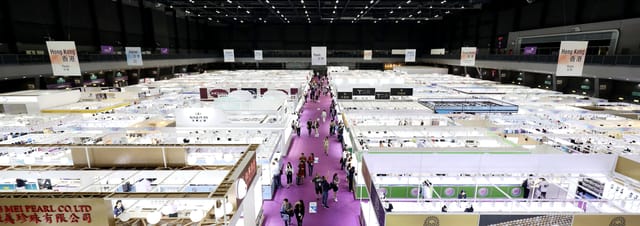 Trade show floor with modular booths and overhead signage for corporate exhibition planning.