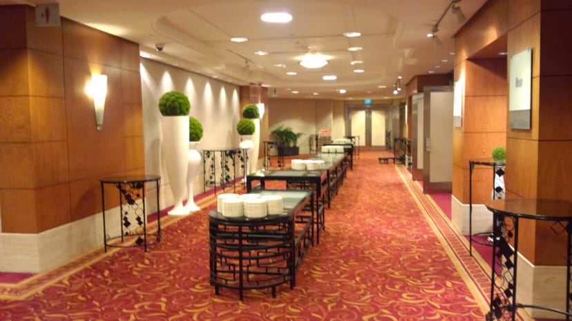 Atrium Ballroom coffee break setup with sleek console tables for corporate events and conferences.