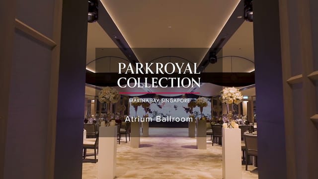 Elegant Atrium Ballroom entrance with floral pedestals for luxury gala or corporate banquet.