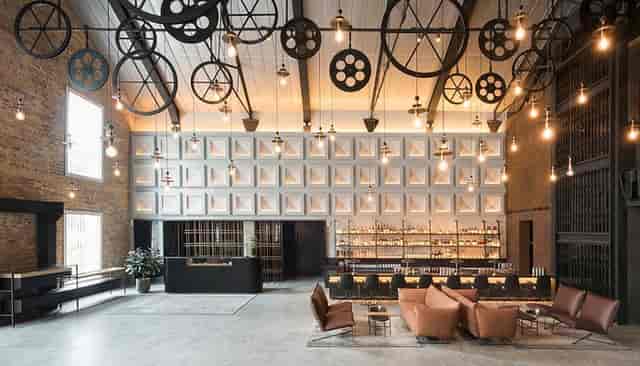 Industrial-chic Warehouse Hotel venue with gear ceiling for networking and product launches.