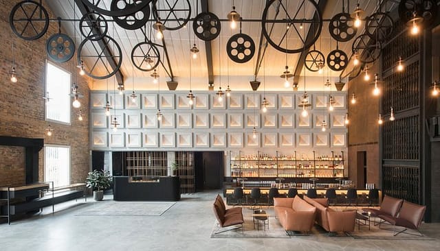 Industrial-chic Warehouse Hotel venue with gear ceiling for networking and product launches.