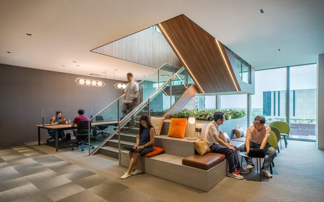 Modern private office at The Work Project CapitaSky with stadium seating for event space and meeting.