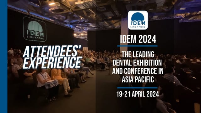 Theater-style breakout session at IDEM 2024 conference, crowded audience in a dark-box hall.