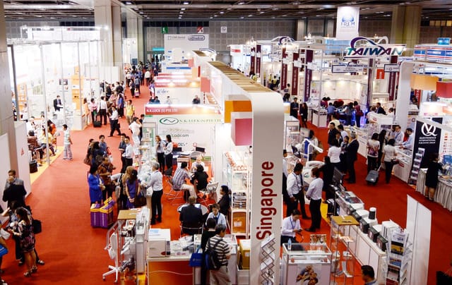 IDEM trade show floor: B2B exhibition hall with networking and national pavilions.