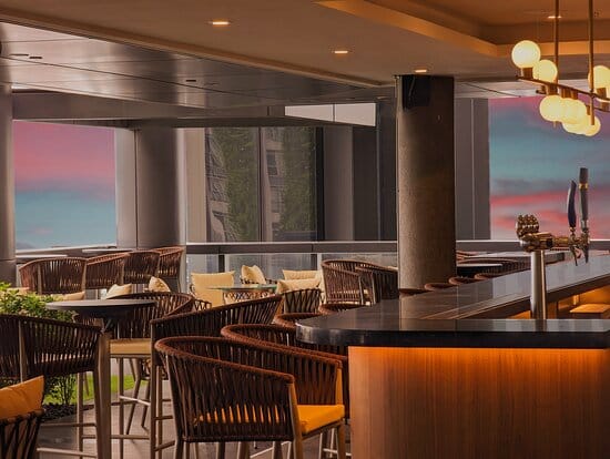 Cooling Tower Rooftop Bar: Sunset reception and networking venue at Carlton City Hotel.