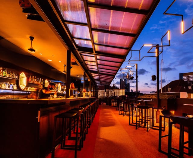 Rooftop bar at golden hour for cocktail receptions and networking events in Tanjong Pagar.